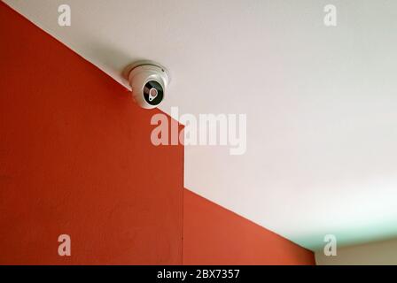 Room of Red and White with a Surveillance Camera on the Ceiling Stock Photo