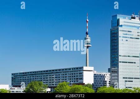 The Donauturm (Danube Tower) behind some buildings of the Donau City in Vienna, Austria. Stock Photo