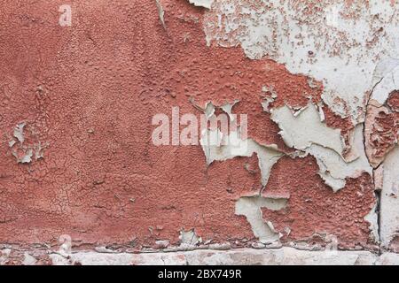 Old flaky cracked paint on gray wall, old paint background, selective focus Stock Photo