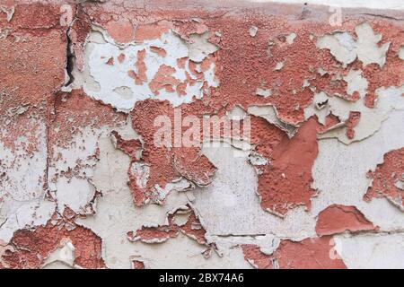 Old flaky cracked paint on gray wall, old paint background, selective focus Stock Photo