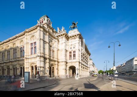 Long exposure shot of the Vienna State Opera (Wiener Staatsoper) with people and traffic passing in Austria. Stock Photo