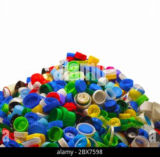 Heap of caps from plastic bottles. Secondary raw material, most often it is HDPE (High-density polyethylene). Stock Photo