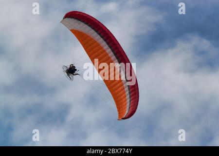 Moto parasailing on a background of blue sky with white clouds