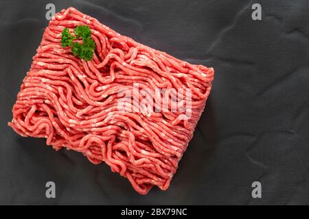 Raw ground beef, top view, on slate. Stock Photo