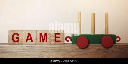 Game word on wooden cubes, and toy train. Business concept background Stock Photo