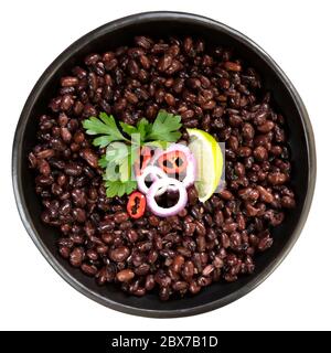 Black beans in rustic dish with onions, chili and lime.  Top view, isolated on white background. Stock Photo