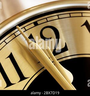 Golden clock face.  Closeup on two minutes to midnight. Stock Photo