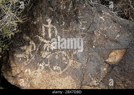 NM00530-00...NEW MEXICO - Petrokgylphs pecked into the desert varnish on a basaltic rock in the Boca Negra Canyon section of Petrogylphs National Monu Stock Photo