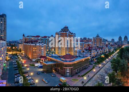 Night aerial view on Obolon area of Kyiv city with illumination. Flying drone camera shot. Stock Photo