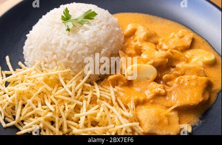 Chicken strogonoff with rice and french fries (potato sticks) on dish. Chicken stroganoff, is a dish originating from Russian cuisine that in Brazil i Stock Photo