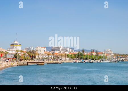 Panoramic view of the seafront shoreline and promenade in central Portimao, western Algarve, south Portugal on a sunny day with clear blue sky Stock Photo
