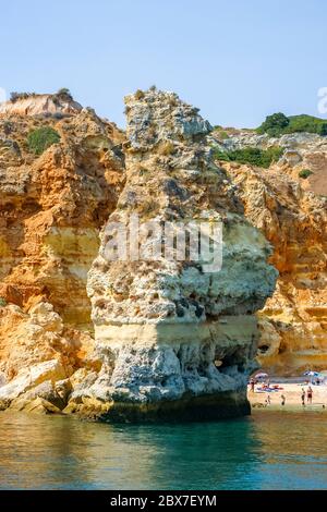 Praia do Torrado by Praia dos Caneiros, a picturesque beach with caves and a rock pillar, Ferragudo, near Portimao, western Algarve, south Portugal Stock Photo