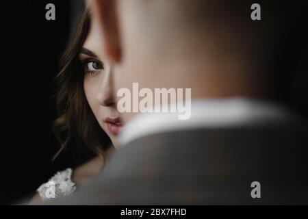 Bride looking over the groom. Bride and groom portrait Stock Photo