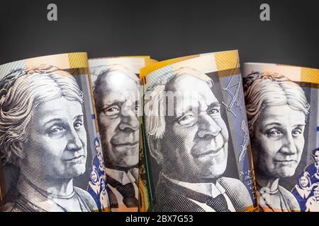 Australian money background.  Fifty dollar notes against dark background. Stock Photo