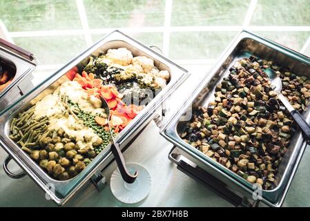 https://l450v.alamy.com/450v/2bx7h8b/two-stainless-hotel-pans-on-food-warmers-warm-vegetable-as-side-dishes-self-service-buffet-table-celebration-party-birthday-or-wedding-concept-2bx7h8b.jpg