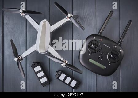 Quad-engine drone with high-resolution camera, batteries and radio control with dual frequency for capturing aerial images Stock Photo