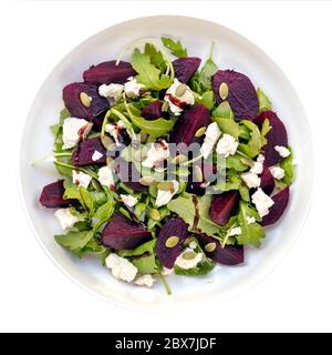 Beetroot salad, isolated, top view.  Includes feta cheese, arugula, and pumpkin seeds. Stock Photo