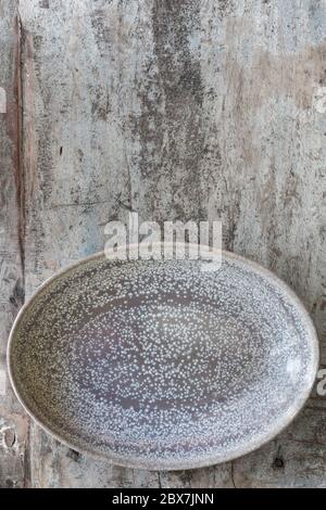 Empty oval dish on rustic timber.  Top view.  Food background. Stock Photo