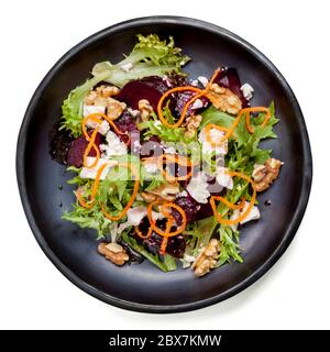 Beetroot salad with feta cheese, walnuts and carrot.  Isolated on white. Stock Photo