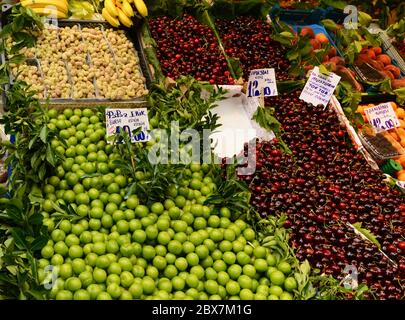 Deep red cherry and green plums and yellow white mulberry Stock Photo