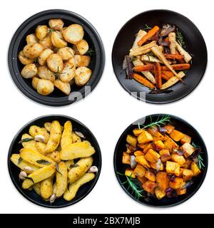 Collection of roasted vegetables on black platters, isolated on white.  Includes potatoes, kumara, parsnips and carrots. Stock Photo