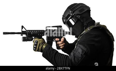 Isolated photo of a fully equipped swat soldier standing and aiming with rifle profile view. Stock Photo