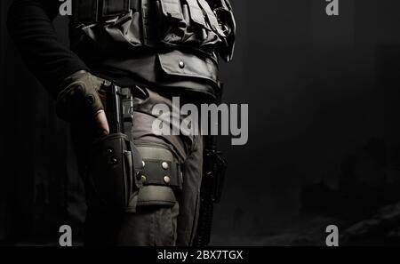 Closeup black and white photo of equipped swat soldier holding a gun profile view. Stock Photo