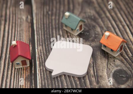Close-up. Several colored houses and paper stickers on a wooden background. Stock Photo
