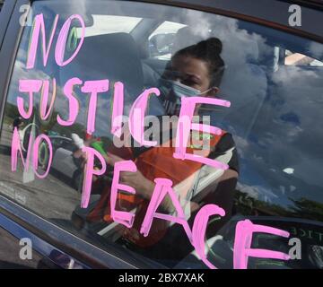 Racine, Wisconsin, USA. 5th June, 2020. Signs are put on cars before an estimated 100 cars motored through Racine, Wisconsin in a 'Caravan for Justice'' Friday June 5, 2020, protesting the killing by Minneapolis police of George Floyd and, a year ago, of Tyrese West by a Village of Mount Pleasant police officer. The caravan ended downtown, between the county courthouse and the county Law Enforcement Center (which houses courtrooms and the county jail) across the street. A rally was held on the steps of the courthouse. Credit: Mark Hertzberg/ZUMA Wire/Alamy Live News Stock Photo