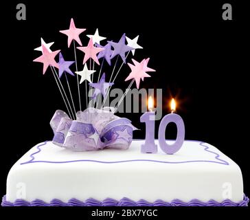 Fancy cake with number 10 candles.  Decorated with star-shapes and ribbons, in pastel tones. Stock Photo
