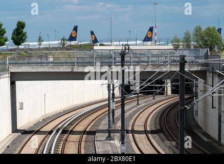 Potsdam, Germany. 02nd June, 2020. The rails of the S-Bahn (l) and the regional railway lead into a tunnel to the underground station of the capital airport. In the background, off the tarmac, there are aircraft of the airline Lufthansa. Credit: Soeren Stache/dpa-Zentralbild/ZB/dpa/Alamy Live News Stock Photo