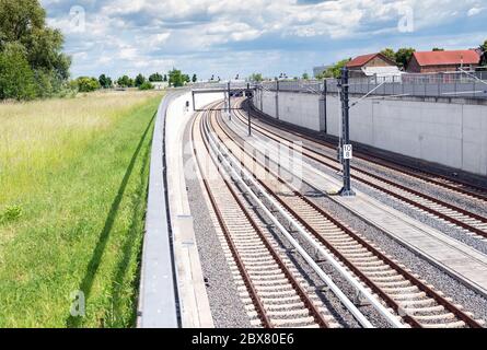 Potsdam, Germany. 02nd June, 2020. The rails of the S-Bahn (l) and the regional railway lead into a tunnel to the underground station of the capital airport. In the background, off the tarmac, there are aircraft of the airline Lufthansa. Credit: Soeren Stache/dpa-Zentralbild/ZB/dpa/Alamy Live News Stock Photo