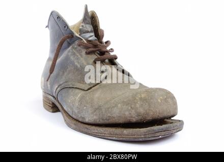 Battered old work boot, falling apart.  My father bought these boots in the 1940's, and wore them until recent years working around his house.  He tel Stock Photo