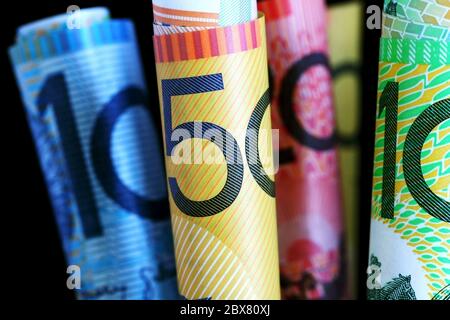 Australian notes, with black background.  Shallow focus on fifty dollar note. Stock Photo