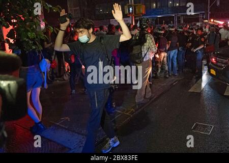 NEW YORK, NY - JUNE 03: Protester walking away with his hands raise as police make dozens of arrests during demonstrations in Manhattan over the killi Stock Photo