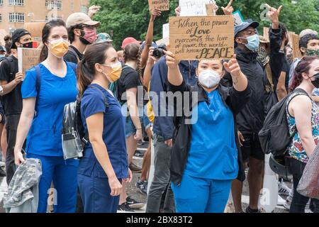 NEW YORK, NY - JUNE 05: Protesters, including Healthcare workers, march and carry signs as demonstrations continue in Manhattan over the killing of Ge Stock Photo