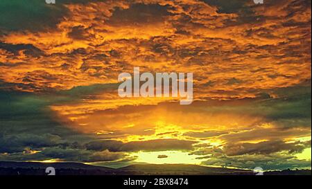 Glasgow, Scotland, UK 6th June, 2020: Spectacular dawn sky over the campsie fell hills north of the city. Credit: Gerard Ferry/Alamy Live News. Stock Photo