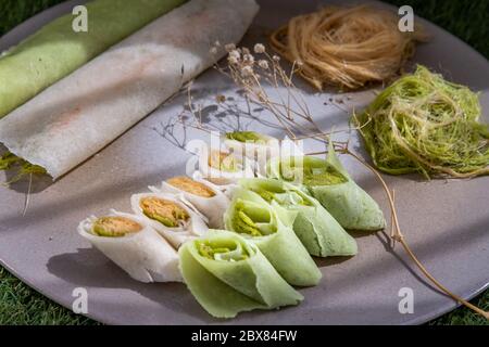 Roti Sai Mai is name of Thai cotton candy wrapped with pastry dough serving with on a white plate. The silk threads roti is one of the favourite Thai Stock Photo