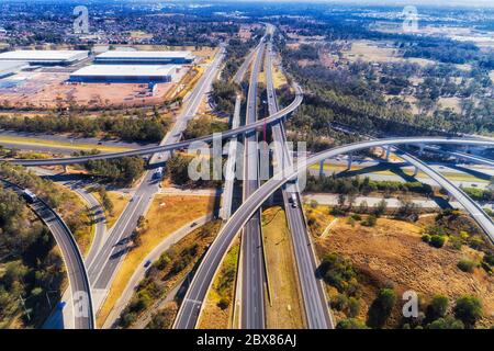 Multi lane major motorways in Western Sydney - multi level lighthorse interchange of M4 and M7 in aerial elevated view above. Stock Photo