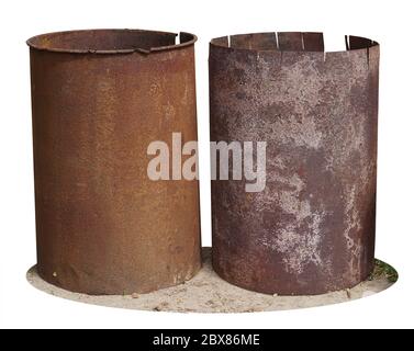 Rusty iron barrels stand on the ground near a village shed. Isolated Stock Photo
