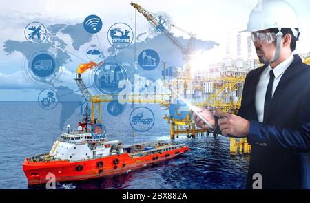 Industrial 4.0 concept.double exposure businessman and icons big data connection manufacturing technology of oil and gas refining industrial. Stock Photo