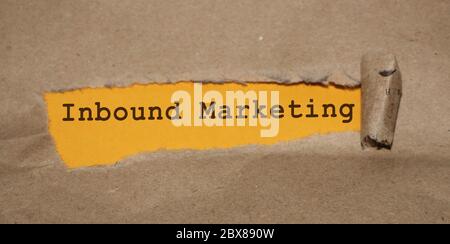 Inbound marketing message written under torn paper. Corywriting storytelling marketing concept Stock Photo
