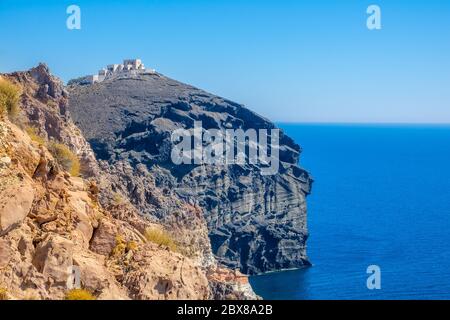 Greece. Sunny summer day on the rocky shore of the Mediterranean Sea. Abandoned hotel construction on top of a blue cliff Stock Photo