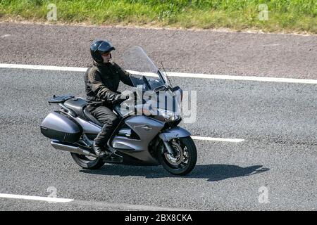 Grey Honda Pan European; Motorbike rider; two wheeled transport, motorcycles, vehicle, roads, motorbikes, bike riders motoring on the M6 motorway Chorley, UK Stock Photo