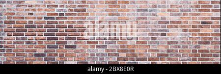 design backdrop. Panoramic background of wide red, yellow and brown brick wall texture. Stock Photo
