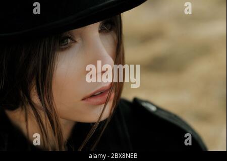 portrait of beautiful girl in hat looking in the field Stock Photo