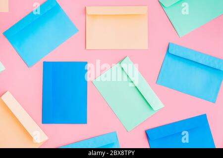 Pattern of colorful correspondence envelopes on pink background. Top view. Stock Photo