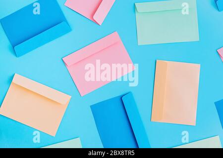 Pattern of colorful correspondence envelopes on blue background. Top view. Stock Photo