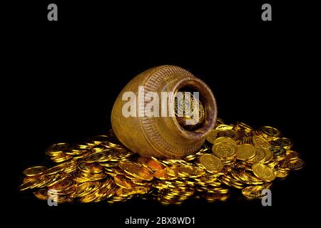 Gold coin in treasure old pot on black background Stock Photo