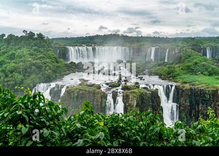 Iguazu Falls seen from the Brazilian side with tousist boat on small lake Stock Photo